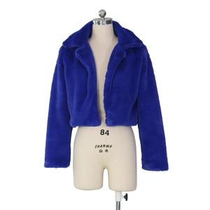 Detail of royal blue faux fur cropped jacket with thick plush texture and lapel collar