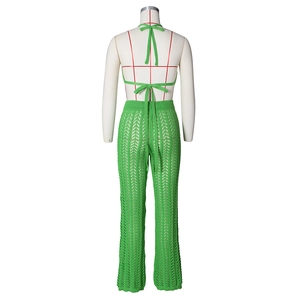 Back view of green crochet knit two-piece set featuring openwork wave patterns on a mannequin