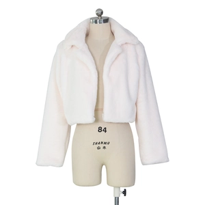 Close-up detail of luxurious white faux fur texture on a cropped collar jacket
