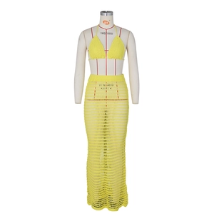Close-up of yellow crochet bikini top and openwork knit long skirt with mesh texture