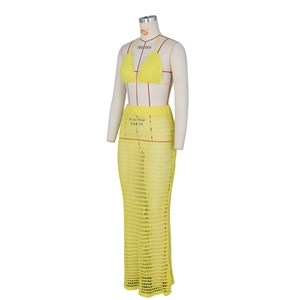 Detailed view of yellow crochet hollow-out knit beach set including halter top and skirt