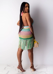 Detail of colorful crochet beach dress featuring open back design and fringed hemline