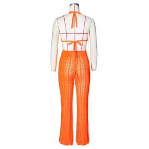 Detail of orange crochet halter top back ties and wave textured flare pants