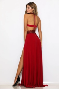 Detail of red backless evening dress with floral lace stitching and high side slit