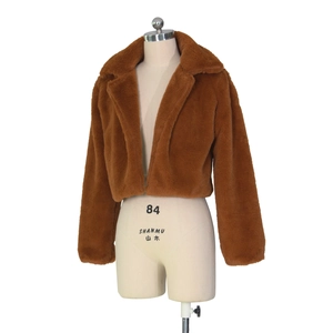 Close-up of caramel faux fur texture on short jacket with large lapel and thick plush