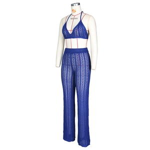 Detail of blue crochet two-piece set featuring wave-pattern knit and halter top