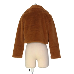 Back view of a cropped faux fur jacket in caramel brown featuring high density plush texture