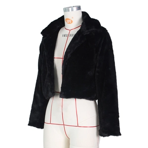 Detail shot of black faux fur short jacket featuring fluffy texture and wide collar