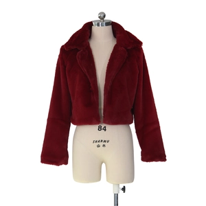 Detail of faux fur texture on a dark red short cropped jacket with lapel collar