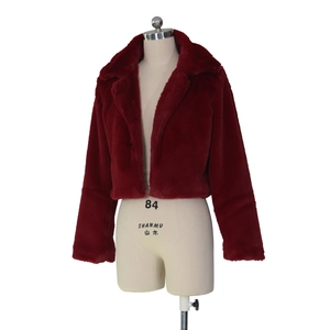 Detail of red faux fur jacket featuring plush long sleeves and a wide spread collar