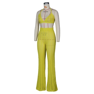 Detailed close-up of bright yellow crochet knit set showing hollow geometric patterns