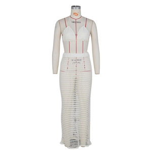Detail of white crochet knit two-piece beach set showing intricate hollow pattern
