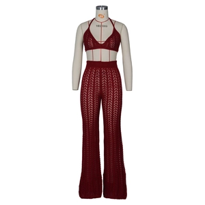 Detail of dark red crochet two-piece set featuring hollow wave patterns and knit texture