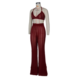Detail of burgundy crochet two-piece set featuring hollow knit texture and halter bra top