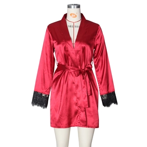 Detail of red satin robe with black lace cuffs and a matching tie waist belt