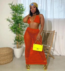 Detail of orange crochet knit two-piece beach set featuring a hollow-out mesh design