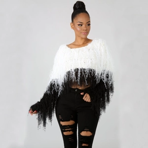 Detail of white and black knit sweater with boho fringe texture for women's street style