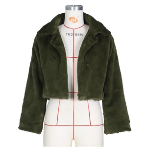 Detail of dark green faux fur jacket showing plush texture and wide notched lapel collar