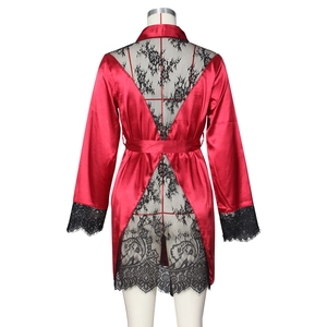 Detail of red satin robe featuring intricate black floral lace patchwork on the back V-neckline