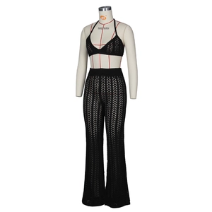 Close-up of black crochet two-piece set featuring cutout halter top and flared pants