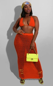 Detail of orange crochet two-piece set featuring hollow mesh knit and scalloped edges