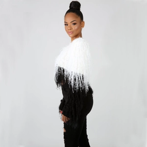 Detail of black and white fringe knit sweater with textured long tassel sleeves
