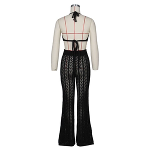 Detail view of the black crochet two-piece set featuring hollow-out knit pants and bra top
