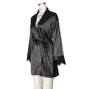 Detail of black satin robe sleeve featuring delicate eyelash lace trim and silk finish