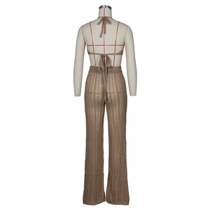 Detail of tan knit crochet two-piece set featuring hollow-out patterns and halter neck top
