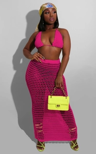 Detail of fuchsia crochet two-piece set featuring halter bikini top and hollow out knit skirt