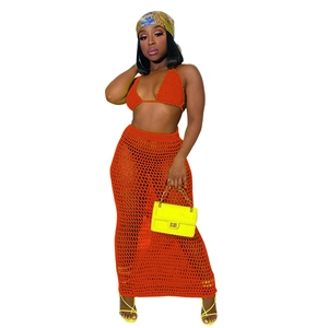 Detailed knit texture of orange crochet two-piece set featuring hollow mesh long skirt