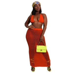 Detail of orange crochet two-piece set featuring halter bikini and mesh hollow beach skirt