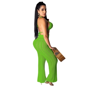 Detail of lime green knit crochet two-piece set featuring halter top and wide leg pants