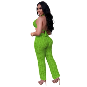 Detail showing bright green crochet knit texture on backless halter top and pants