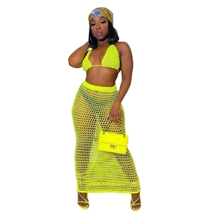 Women's neon green crochet two-piece set with halter bikini top and fishnet maxi skirt