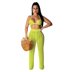 Detail of neon green crochet knit crop top and high waisted wide leg pants