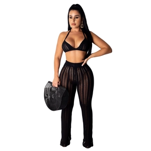 Detailed macro view of black crochet mesh texture on the knitted bikini top and pants set