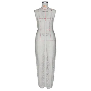 Detail of white crochet knit maxi dress with fringe texture on a tailor mannequin