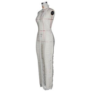 Detail of white crochet beach dress featuring sheer ripped knit and halter neckline texture