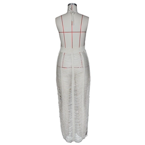 Detail of white crochet knit beach dress with shredded hollow design and halter neckline