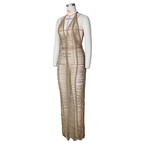 Detail of crochet knit beach dress featuring deep V-neck, open stitch texture and fringe hem