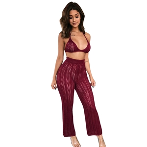 Close-up of burgundy crochet knit two-piece set with hollow geometric patterns
