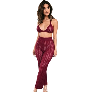 Close-up of wine red crochet knit texture on bikini top and flared trousers set