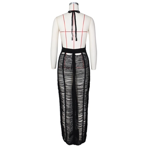 Detailed back view of black knit halter maxi dress with distressed shredded texture details