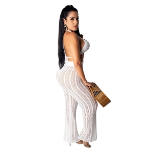 White crochet two-piece set featuring halter neck crop top and high waist wide leg pants