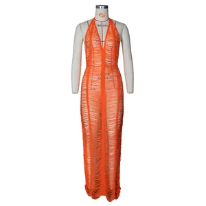 Macro detail of orange knit beach dress showing deep V-neckline and fringe tassels