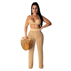 Close-up of beige crochet knit texture on halter bikini top and wide leg pants set