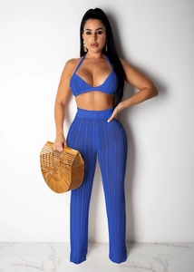 Detail of blue crochet knit two-piece set featuring halter top and high-waist hollowed pants