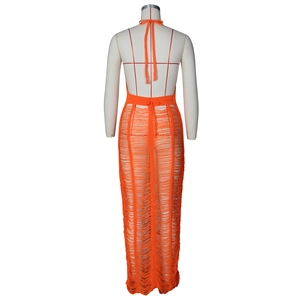Detail of orange crochet beach dress showing open back design and hanging fringe tassels