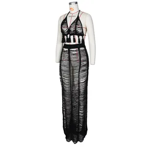 Close-up of black crochet knit texture and tassel details on this beachwear set